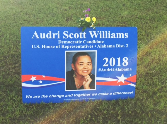 Photo of campaign sign for Audri Scott Williams, posted on a lawn in Cottonwood, Alabama, with flowers atop the post.